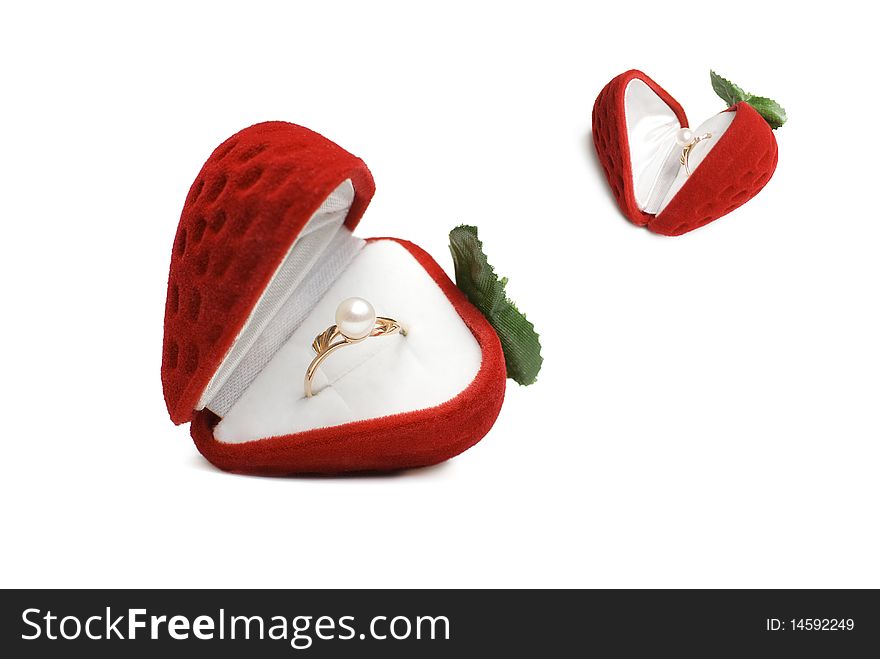 Strawberry box with golden pearl ring isolated on white
