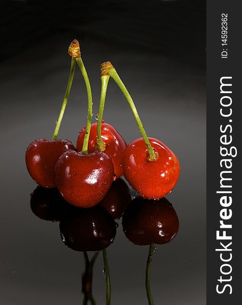 Red Sweet cherry on black plate