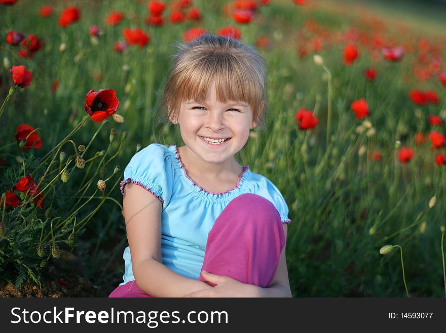 Blond girl on the field of red poppies. Blond girl on the field of red poppies.