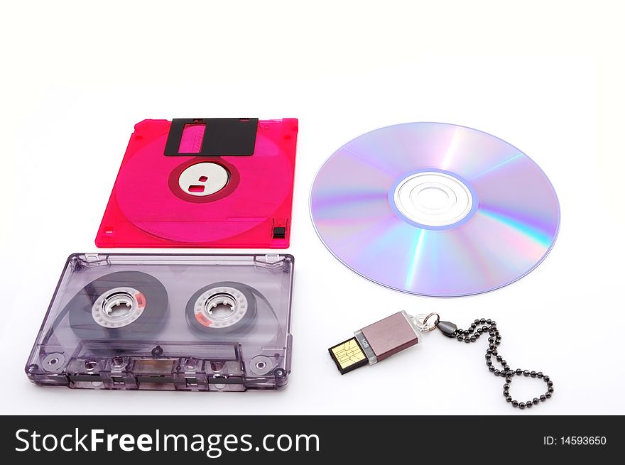 Floppy disk, cassette, compact disc, USB Flash drive is isolated on a white background. Floppy disk, cassette, compact disc, USB Flash drive is isolated on a white background