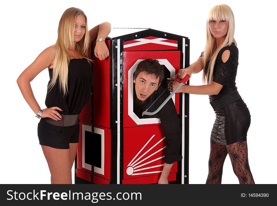 Magician performance and two beauty girls in a magic box with handsaw. Magician performance and two beauty girls in a magic box with handsaw