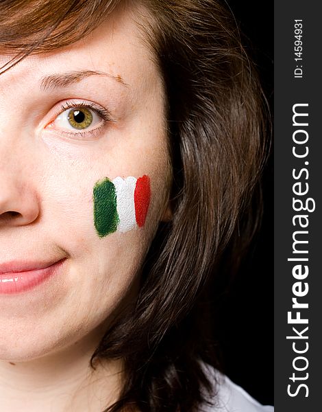 Italian team supporter with flag painted on her cheek, studio shoot isolated on black background. Italian team supporter with flag painted on her cheek, studio shoot isolated on black background