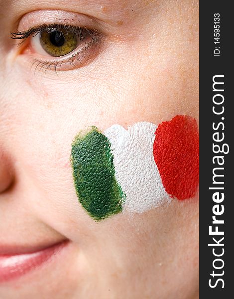 Italian team supporter with flag painted on her cheek, studio shoot isolated on black background. Italian team supporter with flag painted on her cheek, studio shoot isolated on black background