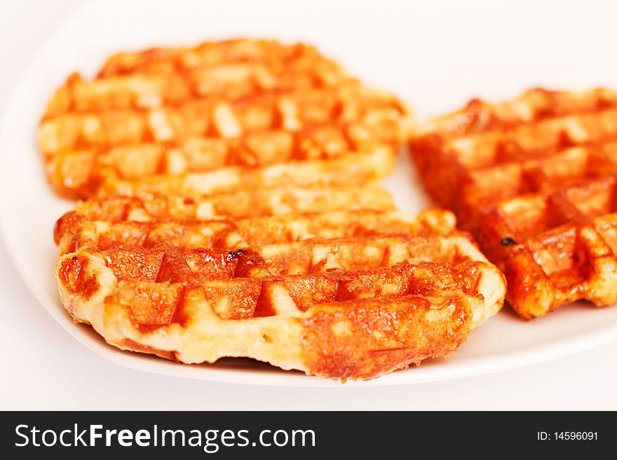 Baked waffles on plate on white background