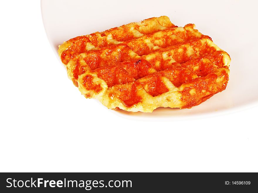 Baked waffle on plate on white background