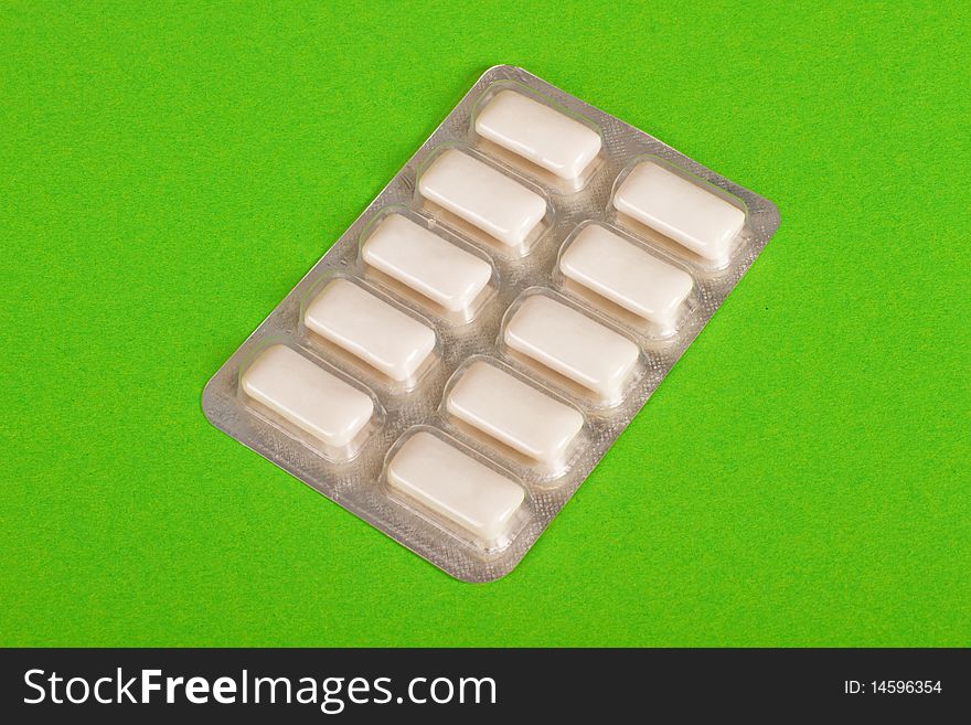 White chewing gum on green background