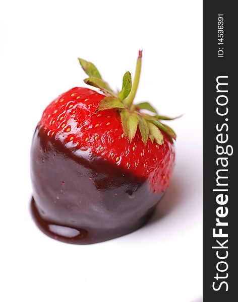Strawberry dipped in melting dark chocolate. Strawberry dipped in melting dark chocolate