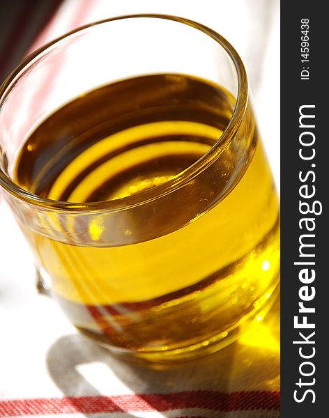 Glass of fresh olive oil