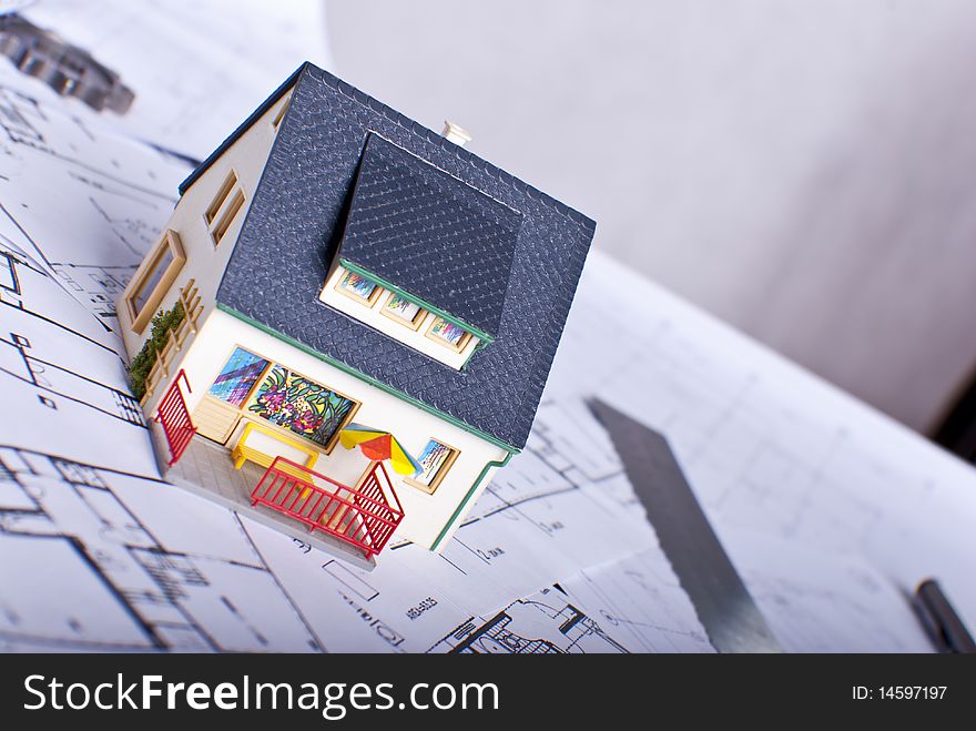Miniature house on plans document. Miniature house on plans document