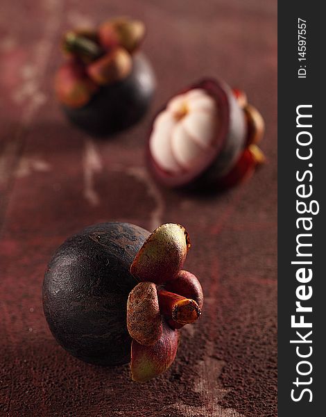 Mangosteens fruit are on a rough background. Mangosteens fruit are on a rough background.