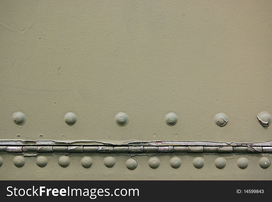 The riveted covering of a fuselage of the old military plane. The riveted covering of a fuselage of the old military plane.