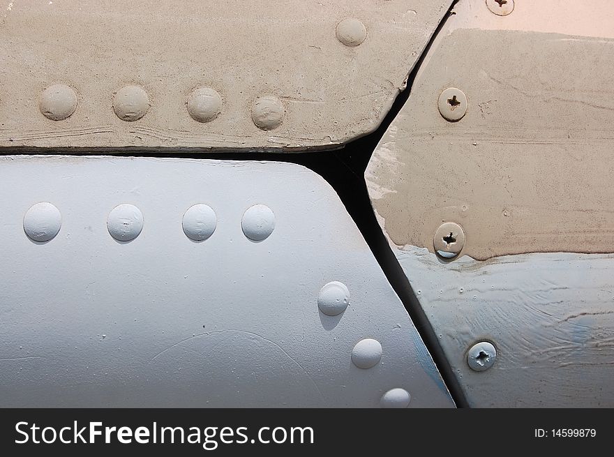 The riveted covering of a fuselage of the old military plane. The riveted covering of a fuselage of the old military plane.