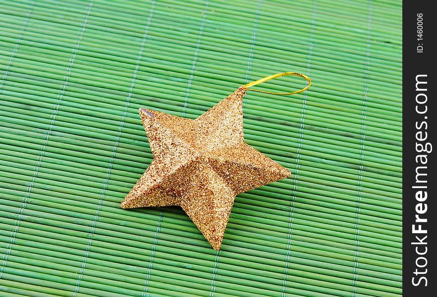 Star shaped Christmas decoration on a green background