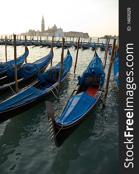 A row of  Gondolas in Venice. A row of  Gondolas in Venice.