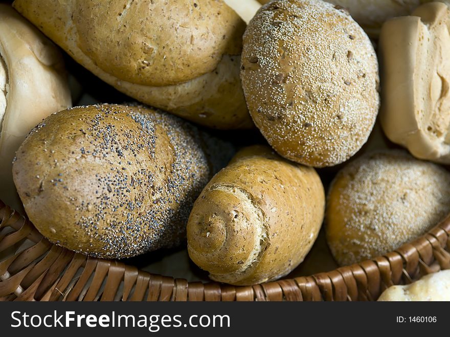 An assortment of breads in a basket. An assortment of breads in a basket