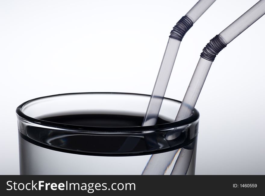 Clear water in a glass with two straws. Clear water in a glass with two straws