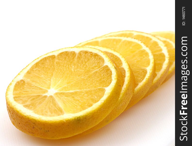 Slices of orange on a white cutting board. Slices of orange on a white cutting board.