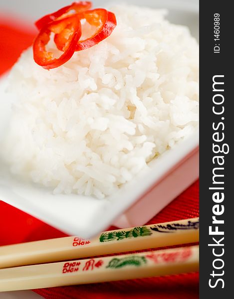 Healthy asian rice dish and chopsticks