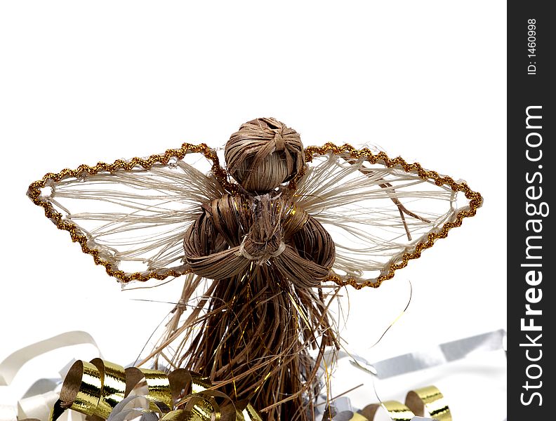 A rustic angel decoration amid colorful streamers and isolated against a white background. A rustic angel decoration amid colorful streamers and isolated against a white background.