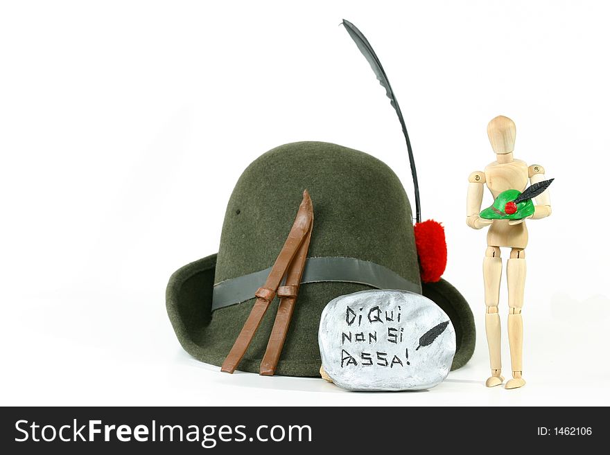 Alpini Hat (the sacred symbol of Italy's elite mountain troops) and skis on a rock. Alpini Hat (the sacred symbol of Italy's elite mountain troops) and skis on a rock.