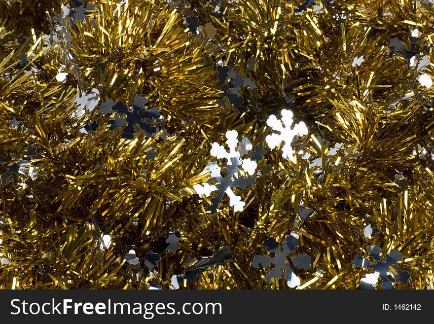 Gold tinsel Christmas garland with silver snowflakes. Gold tinsel Christmas garland with silver snowflakes
