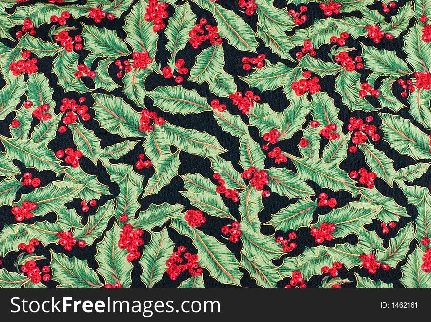 Christmas fabric with a holly leaf and berry pattern. Christmas fabric with a holly leaf and berry pattern