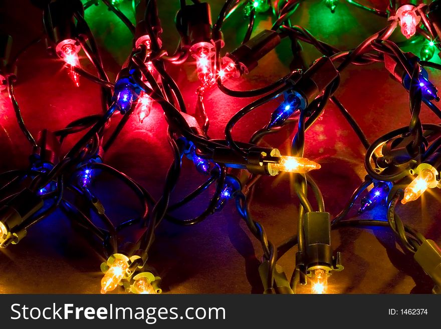 A pile of lit Christmas light strings. A pile of lit Christmas light strings