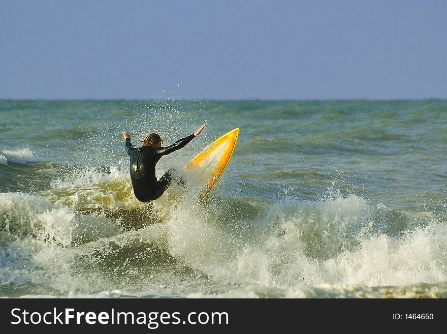 A surfer does some crazy stuf on the waves. A surfer does some crazy stuf on the waves