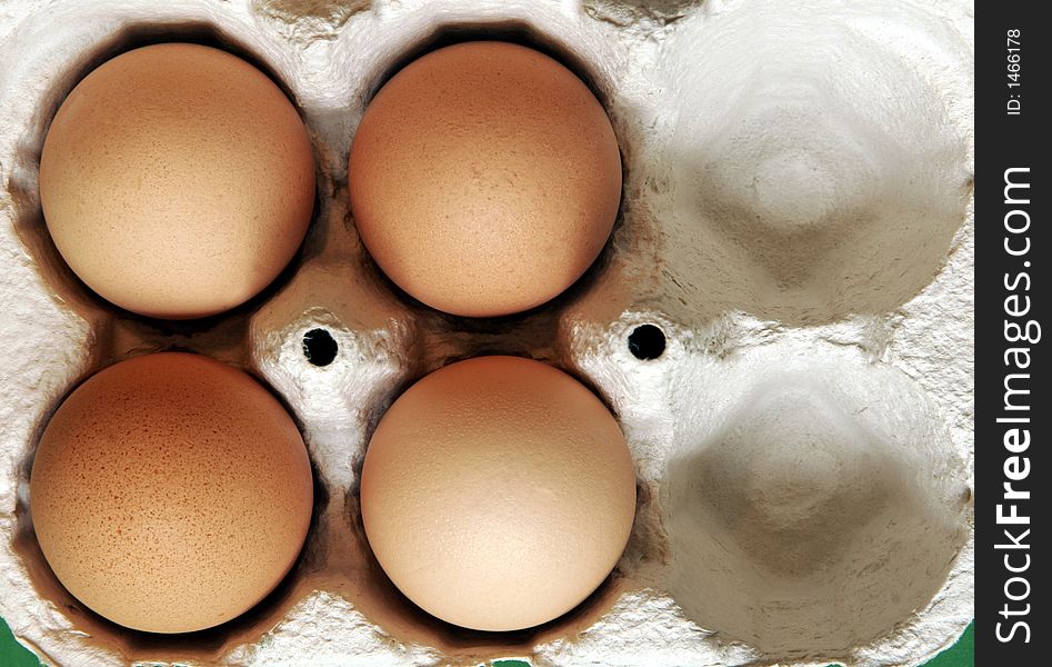 Four Brown Eggs In A Grey Cardboard Box. Four Brown Eggs In A Grey Cardboard Box