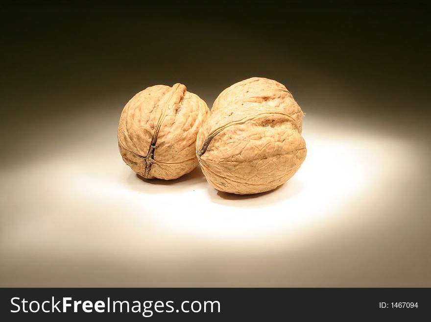 Walnuts on white board in the dark