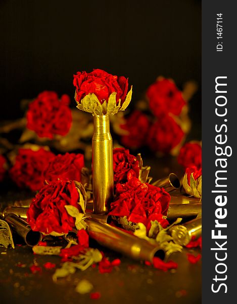 A collection of dried roses with bullet casings. A collection of dried roses with bullet casings