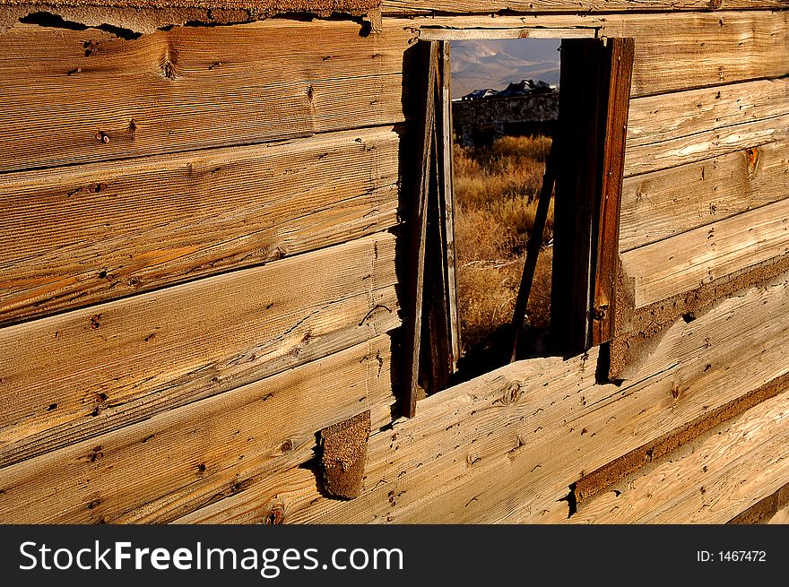 View of the mountains through a old building window. View of the mountains through a old building window