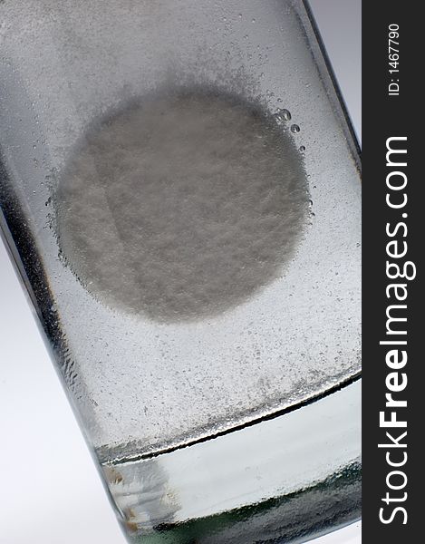 Tablet dissolving in a glass of water