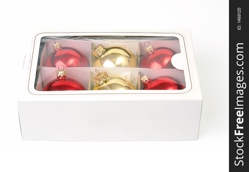 Box of red and golden christmas balls over white background. Box of red and golden christmas balls over white background