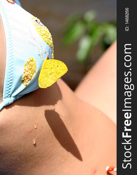 Butterfly sitting on sunbathing woman. Butterfly sitting on sunbathing woman