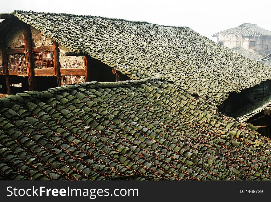 Old folk house with tile roof in morning sunlight