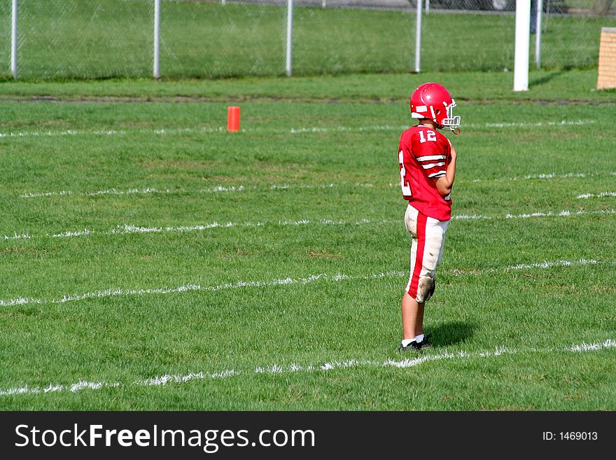 High School Football Player Waiting