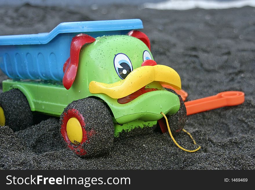 Toy truck in black sand
