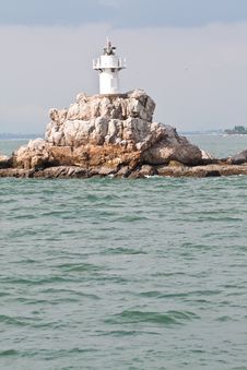 Small Lighthouse In The Sea Stock Photo