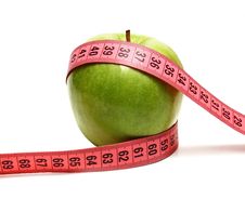 Green Apple And Measuring Ribbon For Diet Royalty Free Stock Photos Green Apple And Measuring Ribbon For Diet Royalty Free Stock Photos