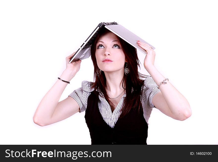 An attractive woman in office environment covering her head with a laptop. An attractive woman in office environment covering her head with a laptop.