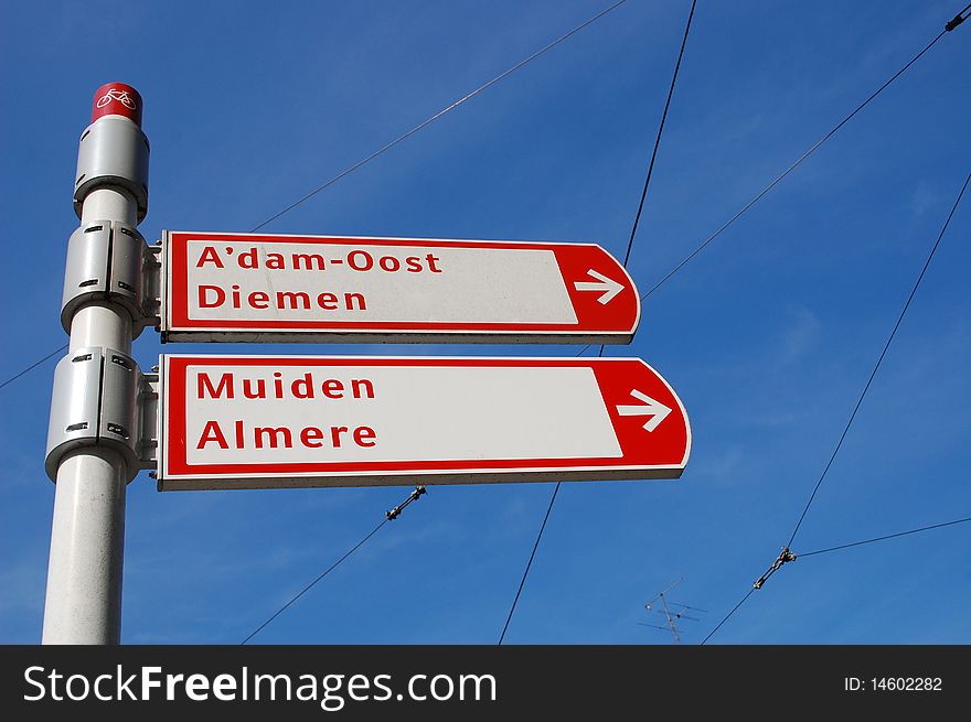 Some route signs in Amsyerdam with a blue sky. Some route signs in Amsyerdam with a blue sky