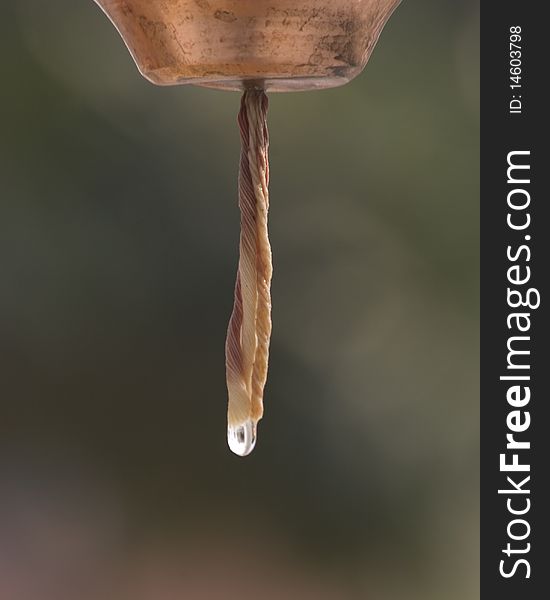 A bell pouring water on a hindu shrine.