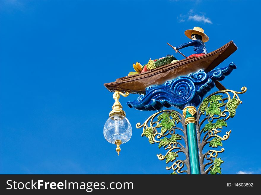 Statue fruit merchant in the boat on electricity post,Floating market,Thailand