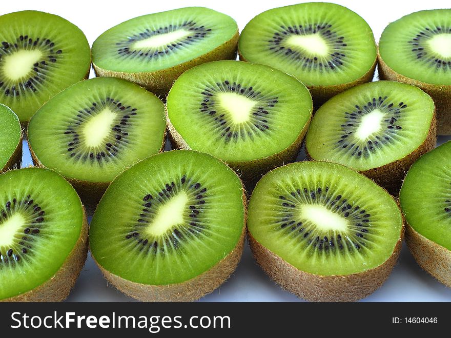 Kiwi fruits cut in half on the white background. Kiwi fruits cut in half on the white background