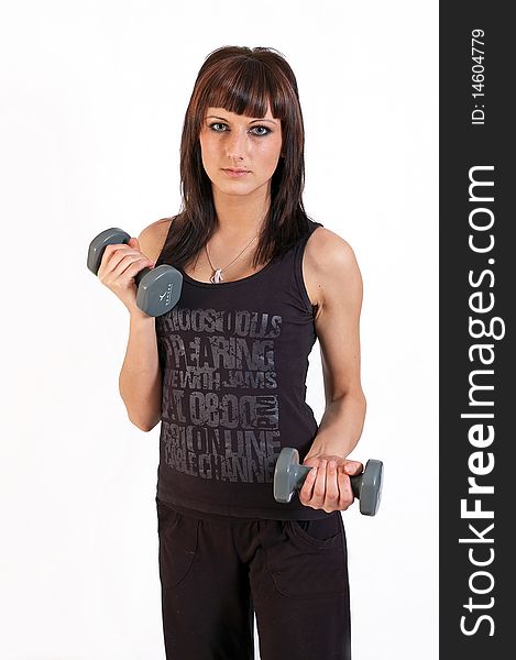 Young woman lifting weights on white background