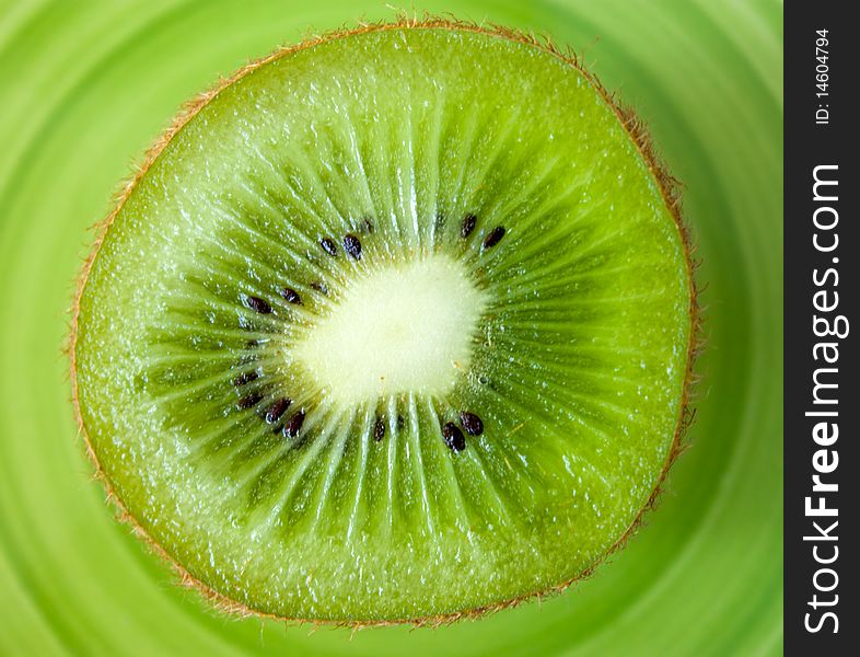 Cuted kiwi on a green plate