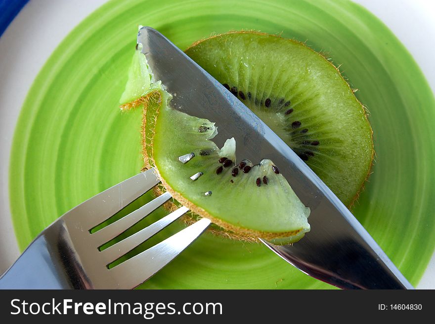 Kiwi cut with a knife on a plate