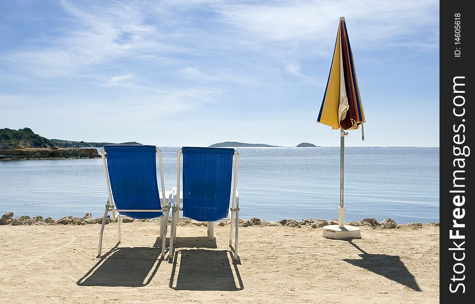 Deck chairs and sunshade in front of the sea. Deck chairs and sunshade in front of the sea