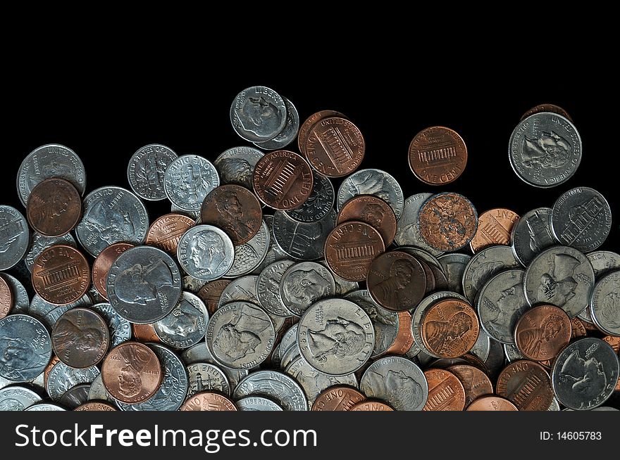 A whole bunch of American coins piled on top of one another to make this background. Isolated on black copyspace with room for your design or text. A whole bunch of American coins piled on top of one another to make this background. Isolated on black copyspace with room for your design or text.